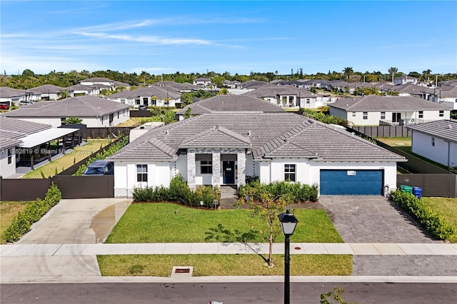 view of front facade with fence, driveway, stucco siding, a tile roof, and a residential view