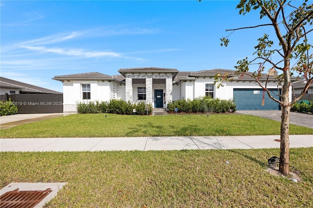 29081 SW 168th Ct, Homestead, FL 33030 - prairie-style house with stucco siding, a front lawn, driveway, an attached garage, and stone siding