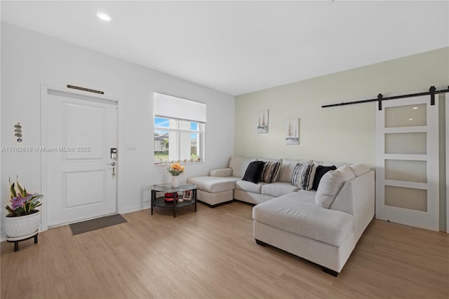 29081 SW 168th Ct, Homestead, FL 33030 - living room with a barn door, light wood finished floors, and recessed lighting