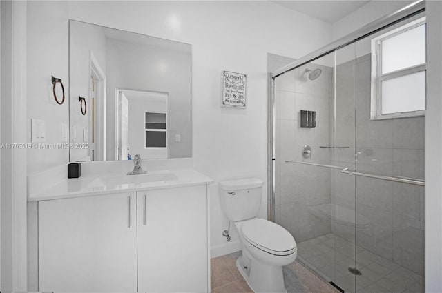 29081 SW 168th Ct, Homestead, FL 33030 - bathroom with toilet, a stall shower, vanity, tile patterned floors, and baseboards