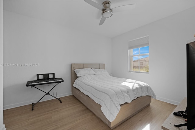 bedroom featuring a ceiling fan, wood finished floors, and baseboards