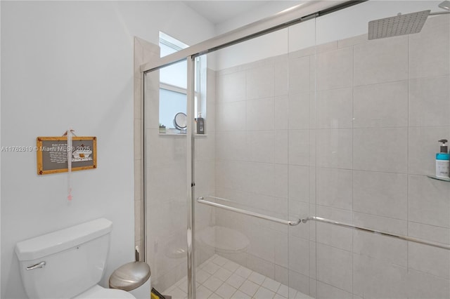 bathroom featuring toilet and a stall shower