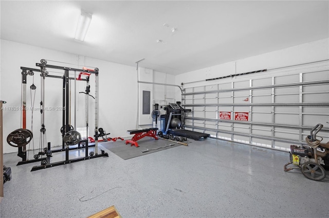 workout room with electric panel and a garage