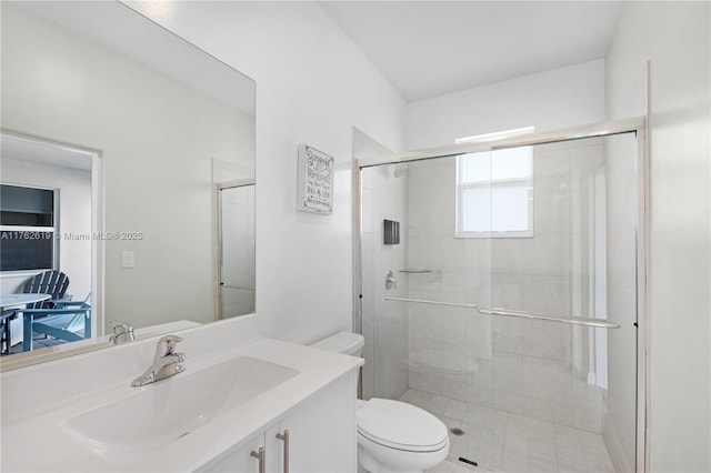 full bath featuring vanity, toilet, and a shower stall