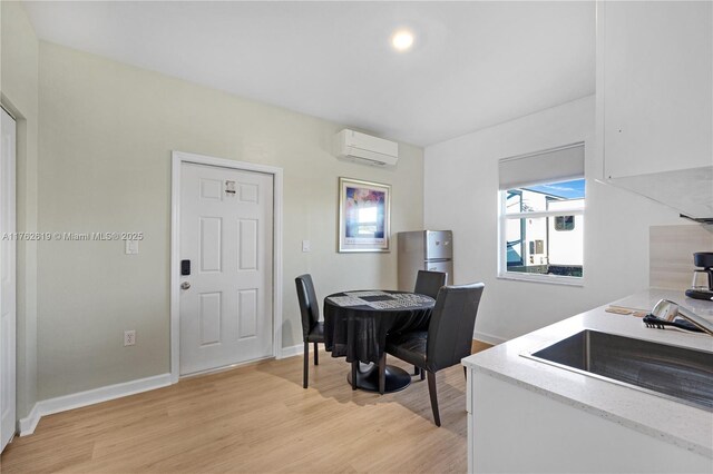 29081 SW 168th Ct, Homestead, FL 33030 - dining space featuring a wall mounted AC, light wood finished floors, and baseboards