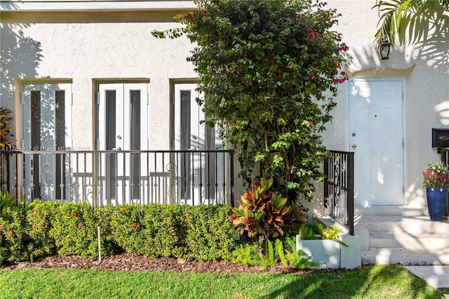 entrance to property with stucco siding