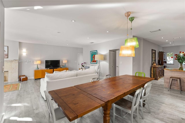 dining area with recessed lighting, light wood-type flooring, baseboards, and visible vents