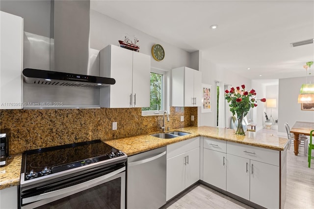 kitchen with visible vents, black electric range oven, a sink, stainless steel dishwasher, and wall chimney range hood