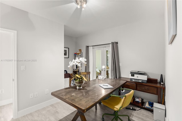 home office featuring baseboards, ceiling fan, and wood finished floors