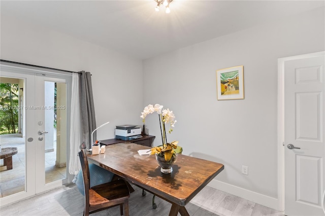 office featuring french doors, baseboards, and light wood-type flooring