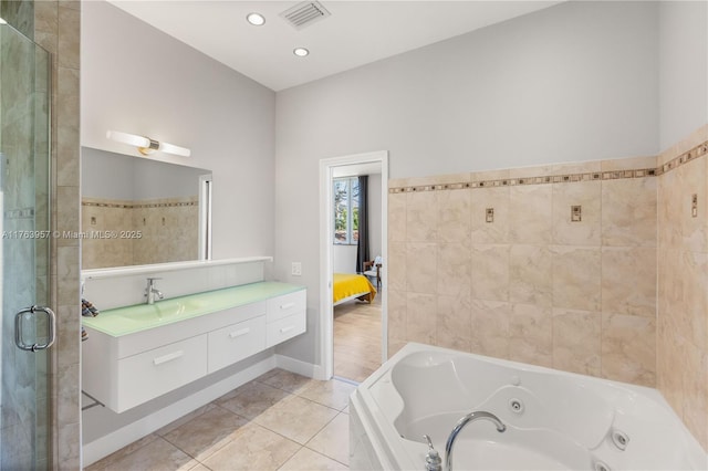 bathroom with tile patterned floors, visible vents, a stall shower, a jetted tub, and vanity