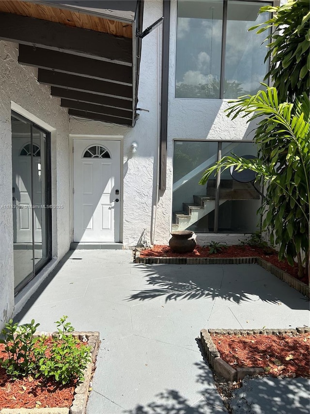 doorway to property with stucco siding