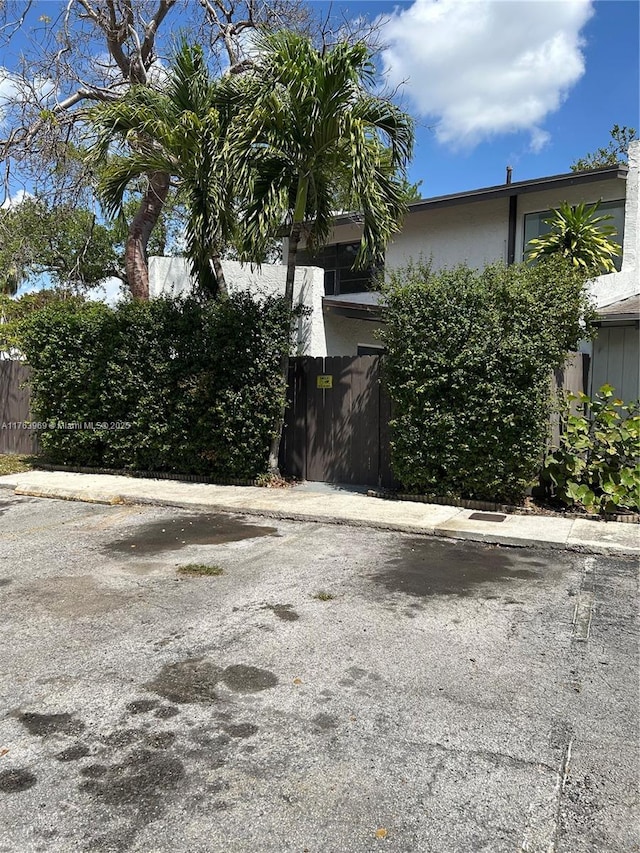 view of side of home featuring fence and stucco siding