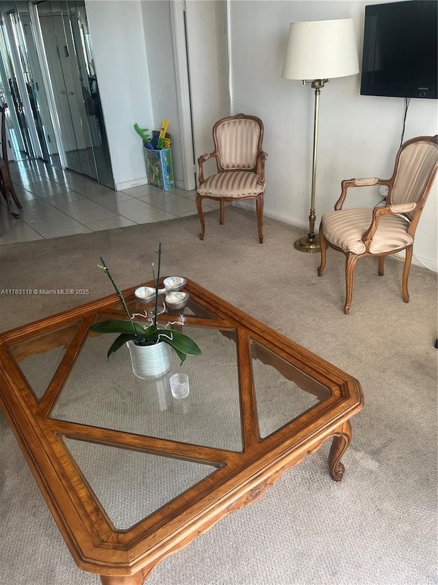 sitting room featuring tile patterned floors and carpet floors