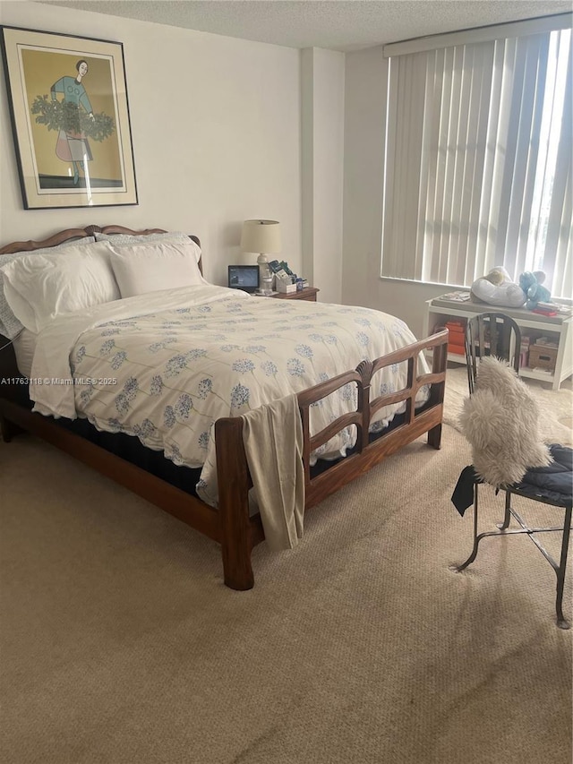 bedroom featuring carpet floors and a textured ceiling