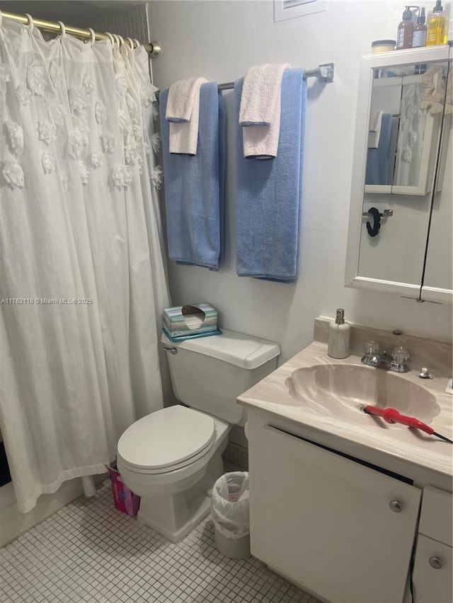 bathroom with tile patterned flooring, a shower with curtain, toilet, and vanity