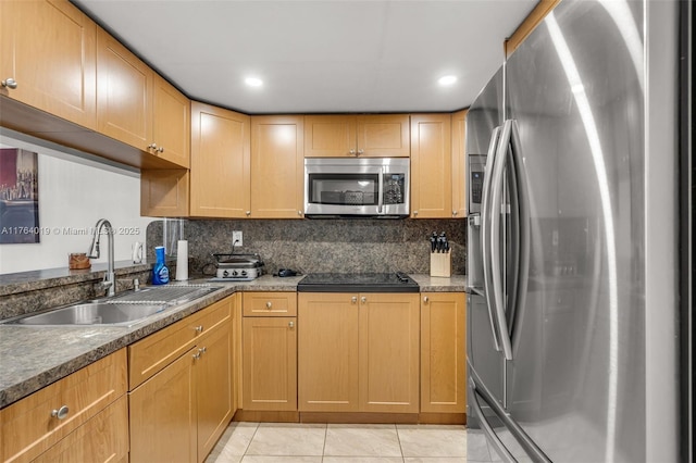 kitchen with a sink, tasteful backsplash, recessed lighting, appliances with stainless steel finishes, and light tile patterned floors