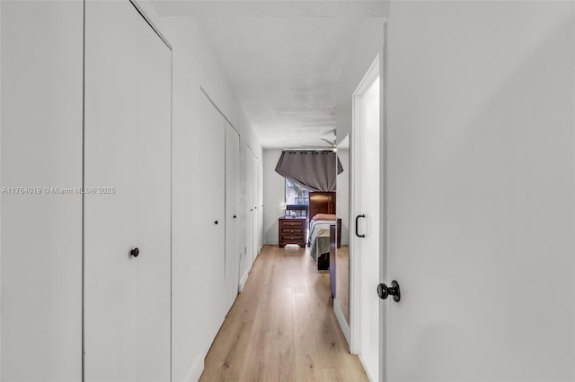 corridor featuring light wood finished floors