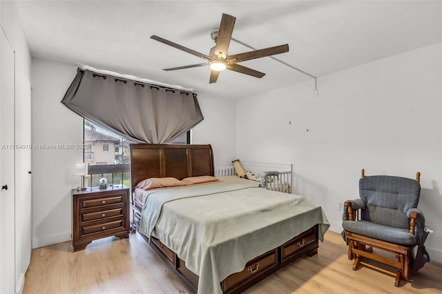 bedroom with ceiling fan and light wood-style floors