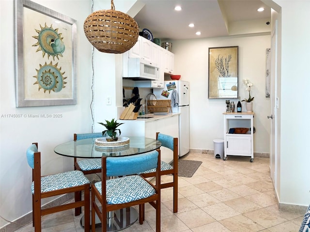 dining room featuring recessed lighting and baseboards