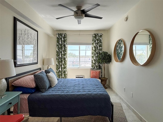 bedroom with a ceiling fan and baseboards