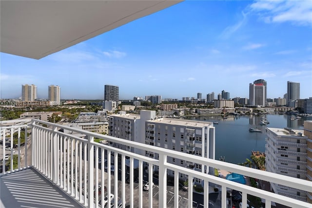 balcony featuring a city view and a water view