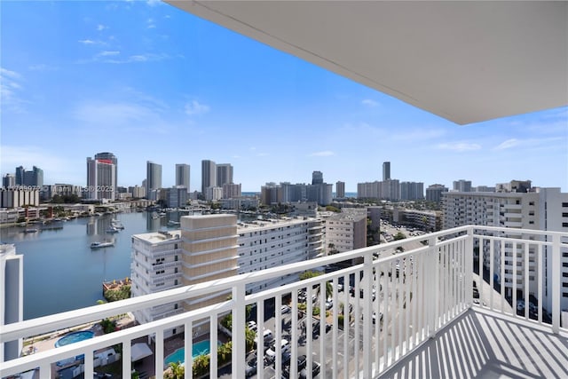 balcony featuring a view of city and a water view