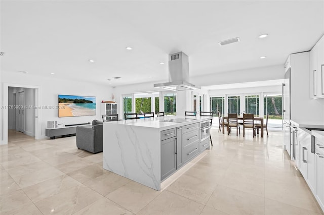 kitchen with plenty of natural light, recessed lighting, visible vents, and island range hood