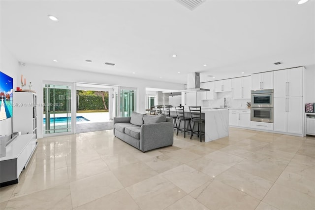 living area with recessed lighting and visible vents