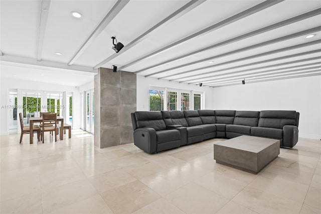 living room with a wealth of natural light, french doors, baseboards, and beamed ceiling