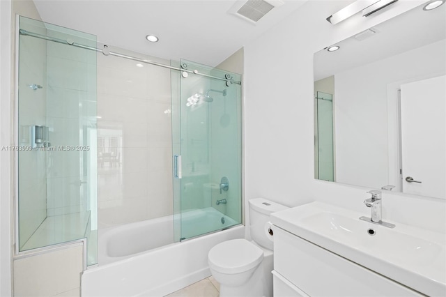 full bathroom featuring tile patterned flooring, visible vents, bath / shower combo with glass door, toilet, and vanity