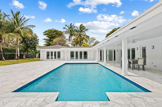 outdoor pool featuring french doors, a patio, and ceiling fan