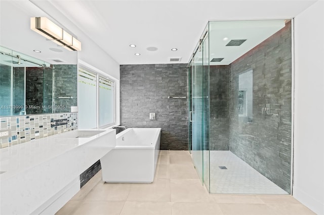 full bathroom featuring visible vents, a soaking tub, a stall shower, tile patterned flooring, and tile walls