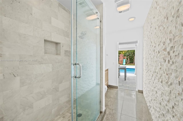 full bathroom featuring baseboards, a shower stall, and tile patterned flooring