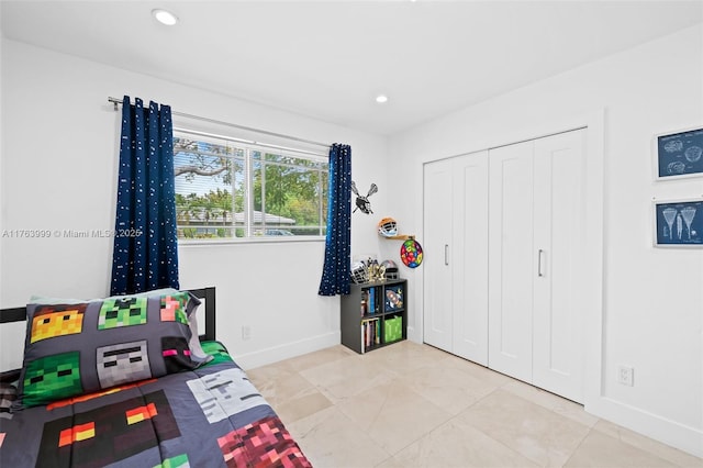 bedroom featuring recessed lighting, a closet, baseboards, and tile patterned flooring