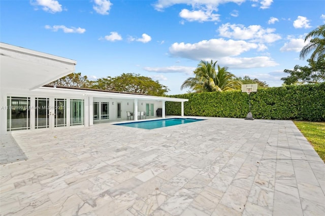 view of pool with a patio, french doors, and a fenced in pool