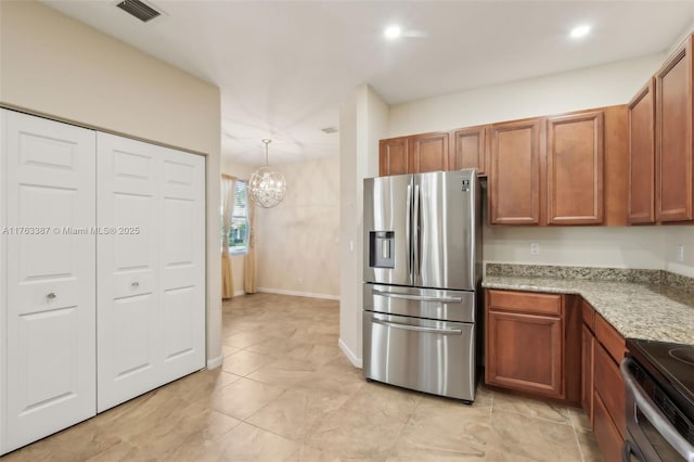 kitchen featuring an inviting chandelier, brown cabinetry, visible vents, and appliances with stainless steel finishes