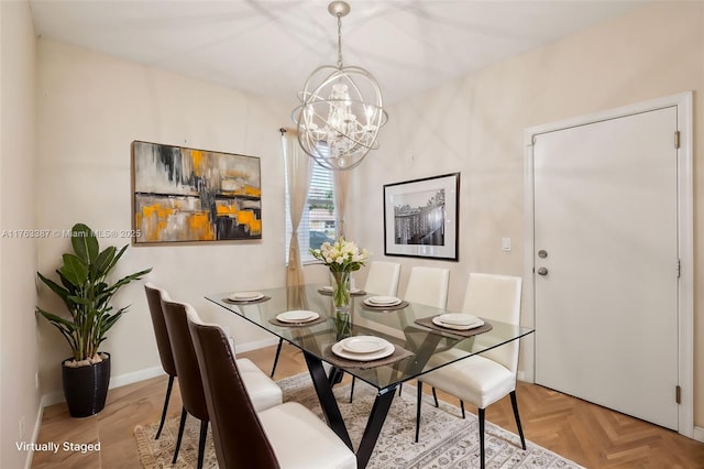 dining area featuring an inviting chandelier and baseboards