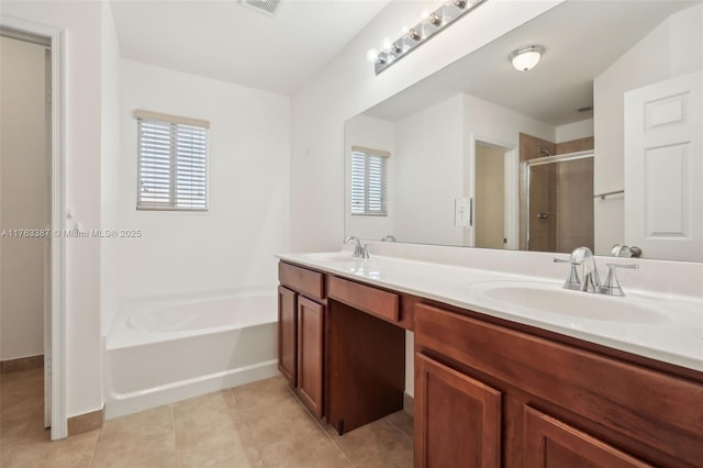 full bath featuring a sink, a garden tub, a shower stall, and tile patterned floors