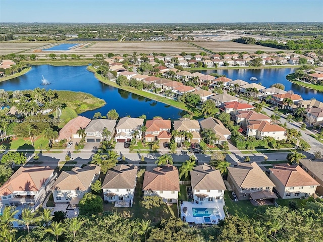 birds eye view of property with a residential view and a water view