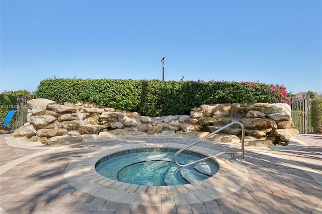 view of swimming pool with an in ground hot tub