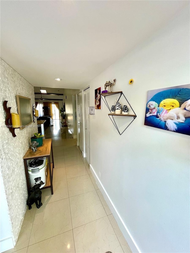 hallway featuring baseboards