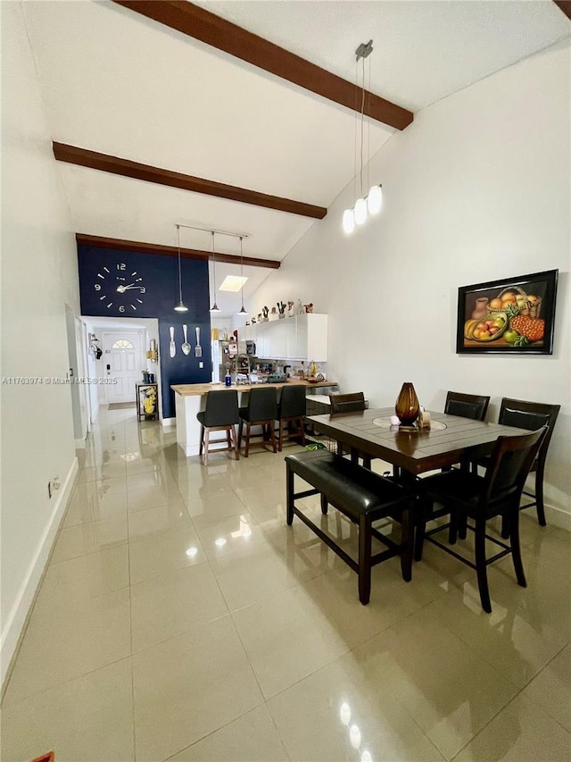 dining space featuring beam ceiling, high vaulted ceiling, baseboards, and light tile patterned flooring