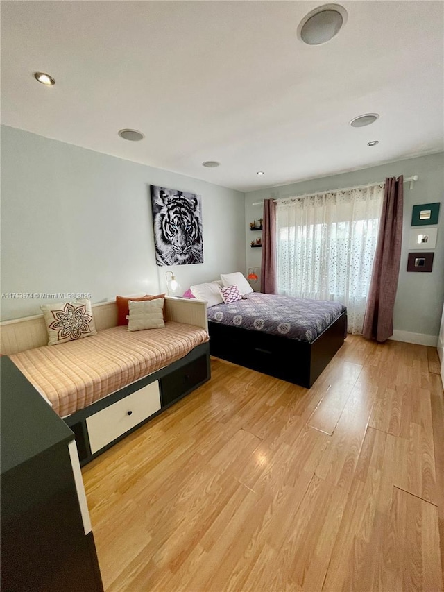 bedroom with baseboards and light wood-style floors