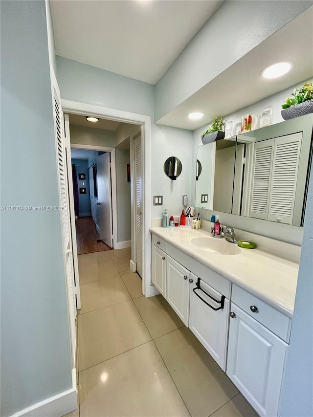 bathroom with recessed lighting, baseboards, vanity, and tile patterned flooring