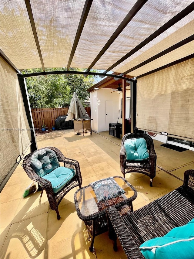 view of patio / terrace with an outdoor living space, fence, and a pergola