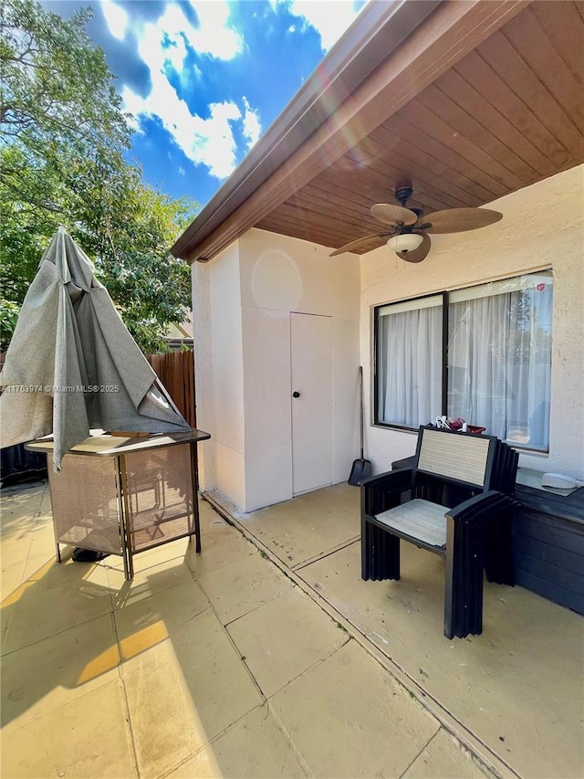 view of patio with a ceiling fan and fence