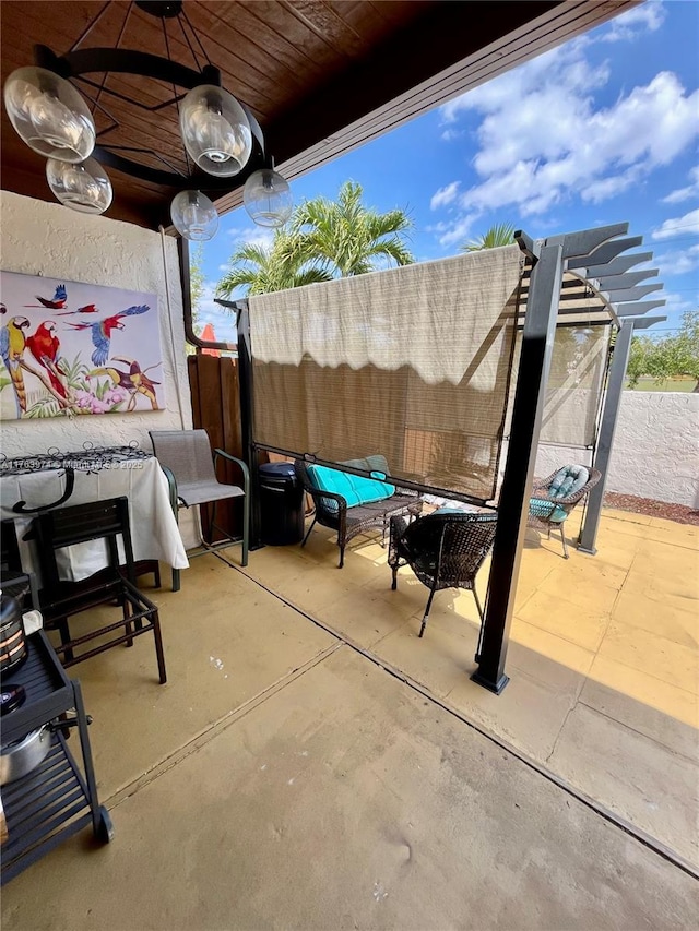 view of patio featuring fence and a pergola