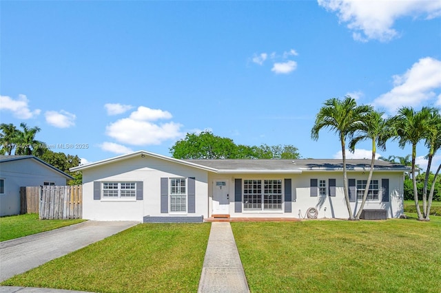 single story home featuring stucco siding, central AC, a front lawn, and fence