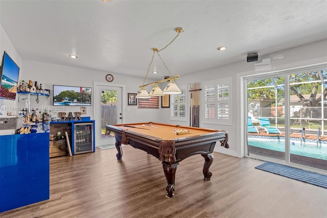 game room featuring a wealth of natural light, wine cooler, pool table, and wood finished floors